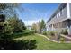 Lush backyard with a well-manicured lawn and mature trees, creating a serene and private outdoor space at 2261 Mustang Chase Dr, Carmel, IN 46074