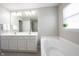 Bright bathroom featuring double sink vanity, soaking tub and natural light at 2261 Mustang Chase Dr, Carmel, IN 46074