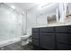 Modern bathroom features glass shower, sleek vanity, wood-look flooring, and neutral walls at 2261 Mustang Chase Dr, Carmel, IN 46074