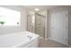 Bright bathroom featuring soaking tub and glass shower with tiled walls at 2261 Mustang Chase Dr, Carmel, IN 46074