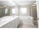 Bright bathroom featuring double sink vanity, soaking tub and glass shower at 2261 Mustang Chase Dr, Carmel, IN 46074