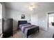 Bedroom featuring a dark wood bed frame, ceiling fan, and neutral carpet, creating a cozy atmosphere at 2261 Mustang Chase Dr, Carmel, IN 46074