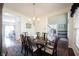 Traditional dining room showcasing a chandelier, and an entrance to the hall with staircase at 2261 Mustang Chase Dr, Carmel, IN 46074
