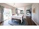 Dining area with wood floors, blue rug, and a pass-through to the living room at 2261 Mustang Chase Dr, Carmel, IN 46074