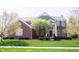 Charming brick two-story home with a well-manicured lawn and mature trees, creating a welcoming curb appeal at 2261 Mustang Chase Dr, Carmel, IN 46074