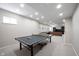 Finished basement game room features a ping pong table, recessed lighting, and natural light at 2261 Mustang Chase Dr, Carmel, IN 46074