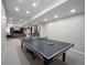 Finished basement game room includes recessed lighting and a full sized ping pong table at 2261 Mustang Chase Dr, Carmel, IN 46074