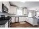 Modern kitchen featuring white cabinets, stainless steel appliances, and dark countertops at 2261 Mustang Chase Dr, Carmel, IN 46074
