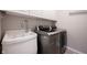 Laundry room with white utility sink and modern stainless steel washer and dryer units at 2261 Mustang Chase Dr, Carmel, IN 46074