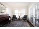 Inviting sitting room features stylish seating, a piano, and decorative accents, creating a sophisticated atmosphere at 2261 Mustang Chase Dr, Carmel, IN 46074