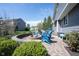 Backyard patio features a firepit surrounded by blue Adirondack chairs at 2261 Mustang Chase Dr, Carmel, IN 46074