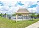Community pool area featuring a gazebo, lounge chairs, and a fenced perimeter for added safety and privacy at 2261 Mustang Chase Dr, Carmel, IN 46074