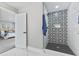 Modern bathroom boasts an elegant shower with decorative tile and a glass door, exuding style and sophistication at 2325 E Brookside Ave, Indianapolis, IN 46218