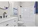 Modern bathroom with sleek vanity, round mirror, and a combined tub and shower at 2325 E Brookside Ave, Indianapolis, IN 46218