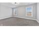 Inviting bedroom with natural light from two windows, neutral walls, and soft carpet exudes a sense of calm at 2325 E Brookside Ave, Indianapolis, IN 46218