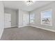 Neutral bedroom with two windows offering natural light and an attached closet for ample storage at 2325 E Brookside Ave, Indianapolis, IN 46218