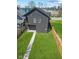 Aerial view of a black two-story home with green grass and a wooden fence at 2325 E Brookside Ave, Indianapolis, IN 46218
