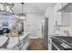 Well-lit kitchen features a central island with a white countertop and stainless steel appliances at 2325 E Brookside Ave, Indianapolis, IN 46218