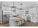 Modern kitchen features white cabinets, stainless steel appliances, and a marble island at 2325 E Brookside Ave, Indianapolis, IN 46218