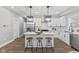 Bright and airy kitchen boasts a center island, stainless steel appliances, and modern lighting at 2325 E Brookside Ave, Indianapolis, IN 46218