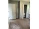 Bedroom with gray walls and tan carpeting and open closet at 2413 N Macedonia Ave, Muncie, IN 47303