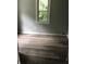 The bedroom has laminate wood-look floors, light-gray paint, and a large window at 2413 N Macedonia Ave, Muncie, IN 47303