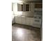 The kitchen has sleek, white cabinets and modern appliances; great layout and plenty of sunlight at 2413 N Macedonia Ave, Muncie, IN 47303