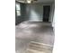 The large carpeted living room has a window, ceiling fan, and light-gray paint at 2413 N Macedonia Ave, Muncie, IN 47303