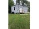 Back exterior with simple back door and a well maintained lawn at 2413 N Macedonia Ave, Muncie, IN 47303