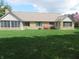 The backyard features a stone house with many windows and a well-manicured lawn at 2427 Cedar Bend Dr, Anderson, IN 46011