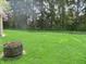 Backyard with a fire pit and lush green grass at 2427 Cedar Bend Dr, Anderson, IN 46011