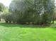 The expansive backyard is bordered by lush greenery, enhancing privacy at 2427 Cedar Bend Dr, Anderson, IN 46011