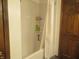 Bathroom with a tiled shower, white curtain and built in shelves at 2427 Cedar Bend Dr, Anderson, IN 46011