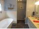 Bright bathroom featuring a modern soaking tub, dual sinks, and stylish fixtures at 2427 Cedar Bend Dr, Anderson, IN 46011