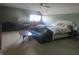 Spacious primary bedroom with a ceiling fan, couches, and natural lighting at 2427 Cedar Bend Dr, Anderson, IN 46011