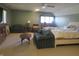 Spacious primary bedroom with a ceiling fan, couches, and natural lighting at 2427 Cedar Bend Dr, Anderson, IN 46011