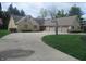 Long circular driveway leading to a three car garage on a well maintained lawn at 2427 Cedar Bend Dr, Anderson, IN 46011