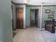 Inviting entryway with tile flooring, a wooden front door, and views of the living area at 2427 Cedar Bend Dr, Anderson, IN 46011