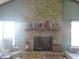 Living room showcasing a stone fireplace and bright lighting at 2427 Cedar Bend Dr, Anderson, IN 46011