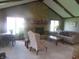 Bright living room with a stone fireplace, large windows, and comfortable seating area at 2427 Cedar Bend Dr, Anderson, IN 46011