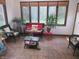 Cozy sunroom filled with natural light, wicker furniture, and views of the green outdoors at 2427 Cedar Bend Dr, Anderson, IN 46011