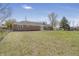 Exterior backyard view of a brick home with a green lawn and mature trees at 2526 David Dr, Westfield, IN 46074