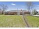 Backyard view of a brick home with a wooden deck and a chain-link fence at 2526 David Dr, Westfield, IN 46074