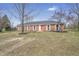 Charming single-story brick home with a red front door and well-manicured landscaping at 2526 David Dr, Westfield, IN 46074