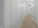 Well lit hallway with neutral walls and modern flooring at 2526 David Dr, Westfield, IN 46074