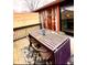 Outdoor deck with dining set, rustic accent wall, and serene backyard view at 256 Riverwood Dr, Noblesville, IN 46062