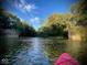 Beautiful river view with a red kayak in the foreground and lush greenery along the banks at 256 Riverwood Dr, Noblesville, IN 46062