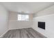 Basement featuring wood floors, a white painted fireplace, and natural light from the window at 2601 Fairhaven Dr, Indianapolis, IN 46229