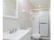 Bright bathroom with a white vanity, shower with sliding glass door, and modern fixtures at 2601 Fairhaven Dr, Indianapolis, IN 46229
