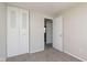 Bedroom with neutral carpet, closet doors, and an entrance to another room at 2601 Fairhaven Dr, Indianapolis, IN 46229
